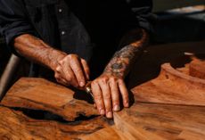 Ido Yoshimoto's workshop in Inverness, California, photographed under a blue sky and with wooden elements from his production